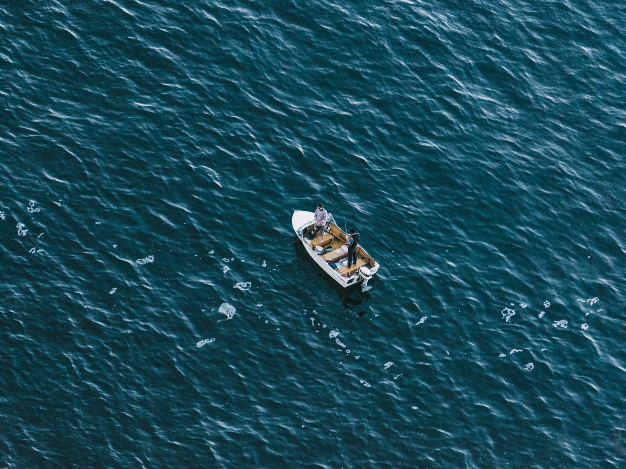A small fishing boat on the open water off Sydney, seen from above